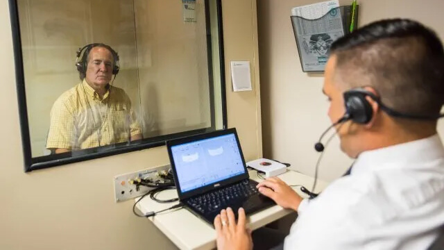 Adam Wentling giving patient a hearing test