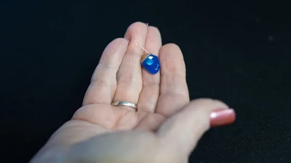 Hearing aid in palm of hand